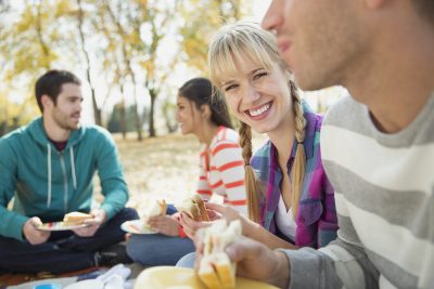 Friends having a picnic in park